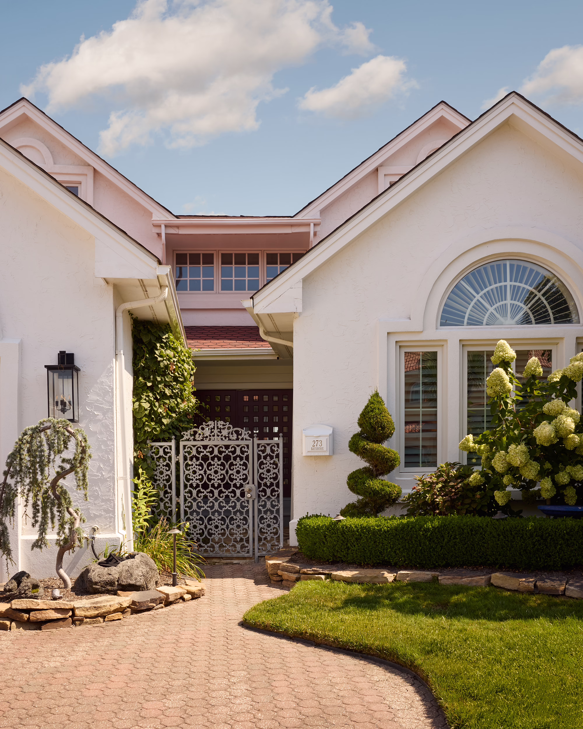 Bayshore front entrance with a white stucco exterior and landscaped garden