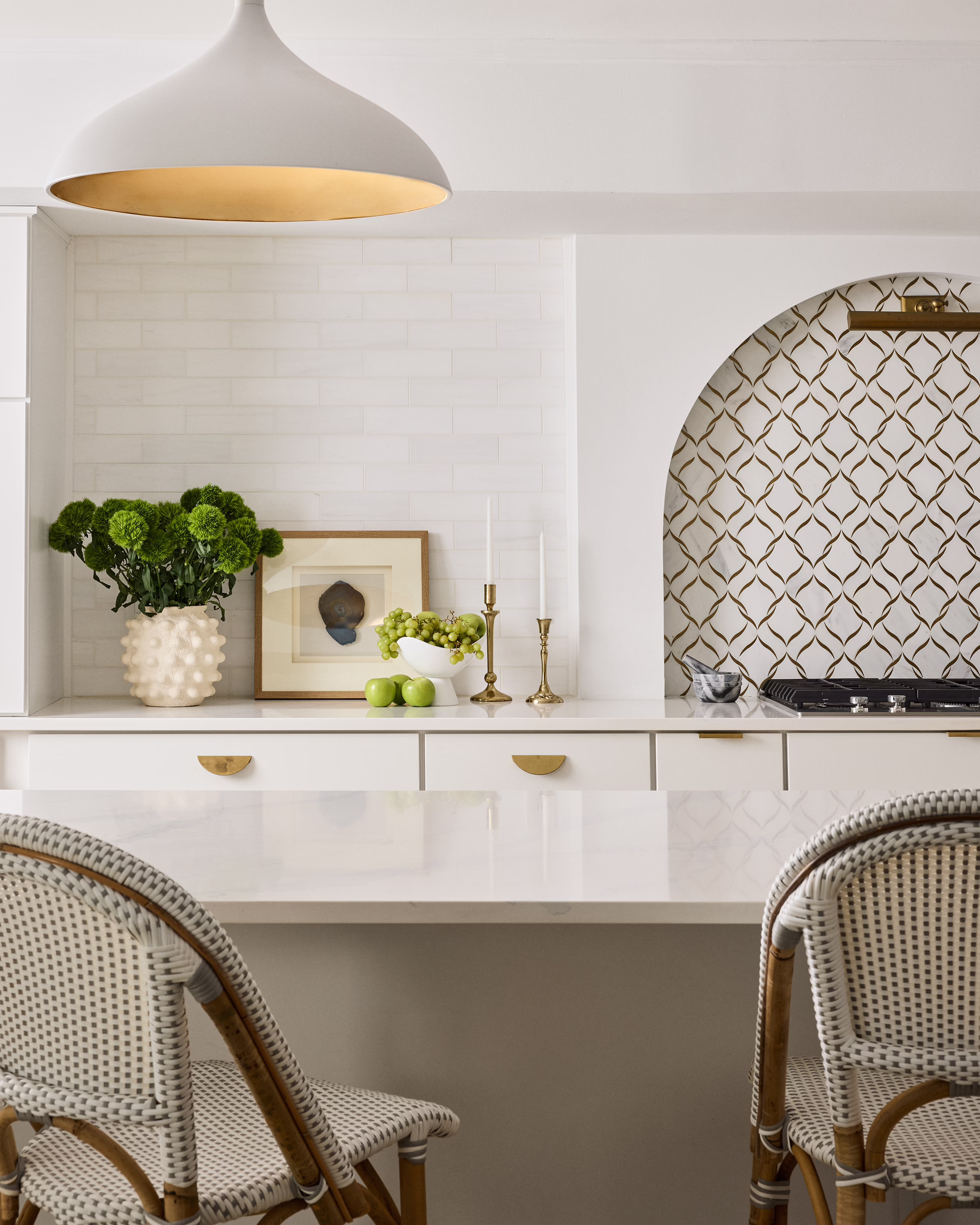 Bayshore kitchen bar with woven chairs and a patterned arched alcove