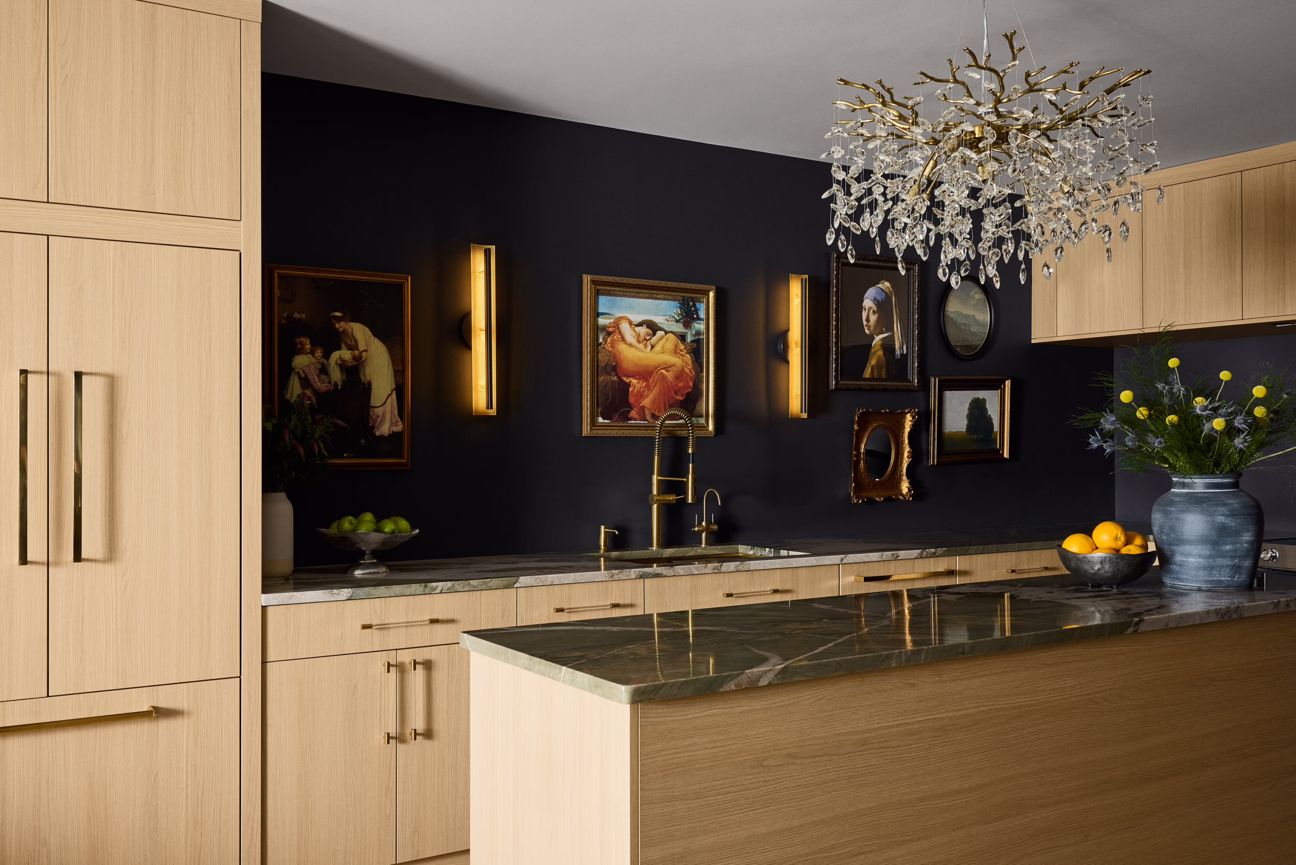 Kings Ct. kitchen with light wood cabinetry, black walls, framed artwork and a crystal chandelier