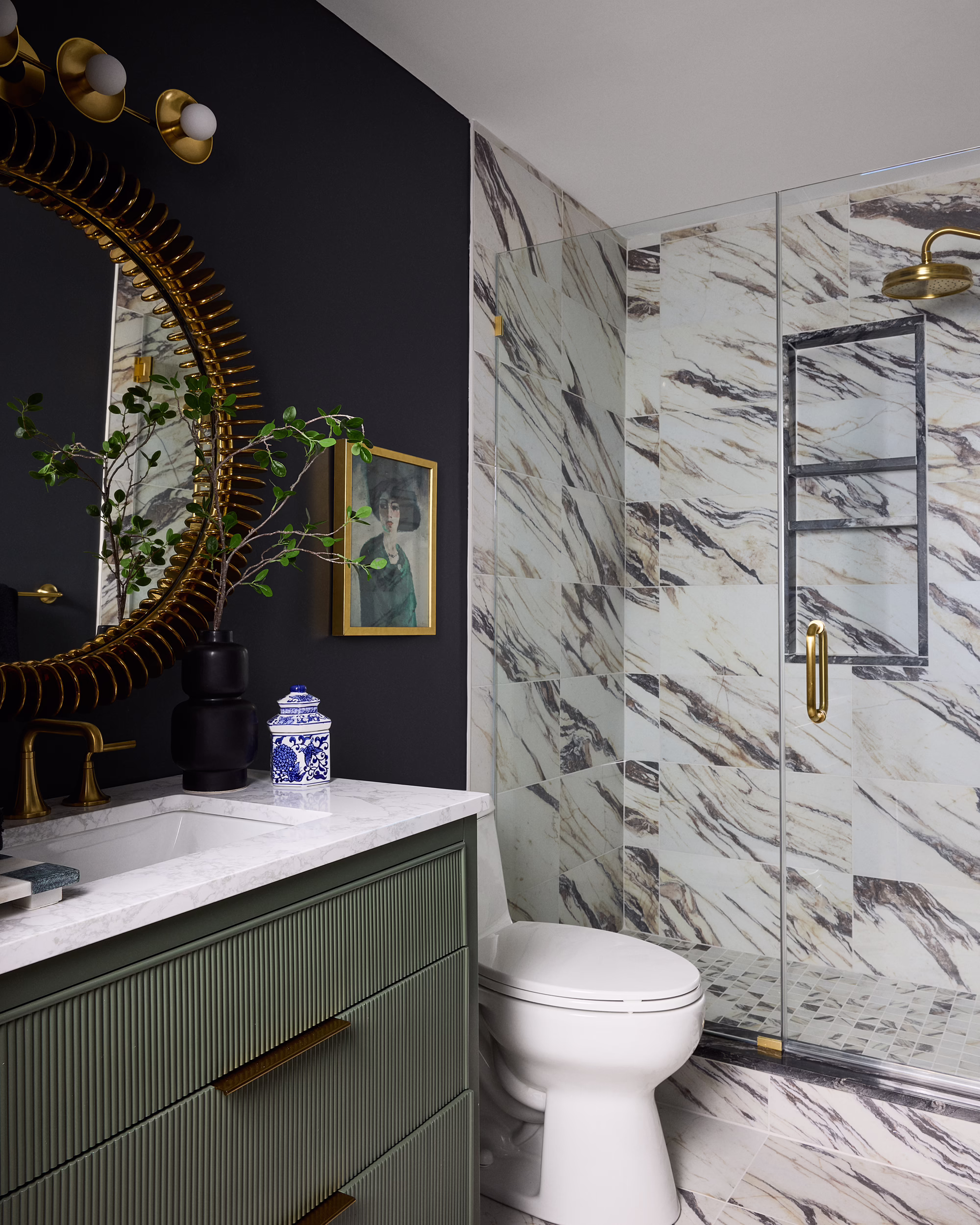 Kings Ct. bathroom with a green vanity, round mirror and marble shower