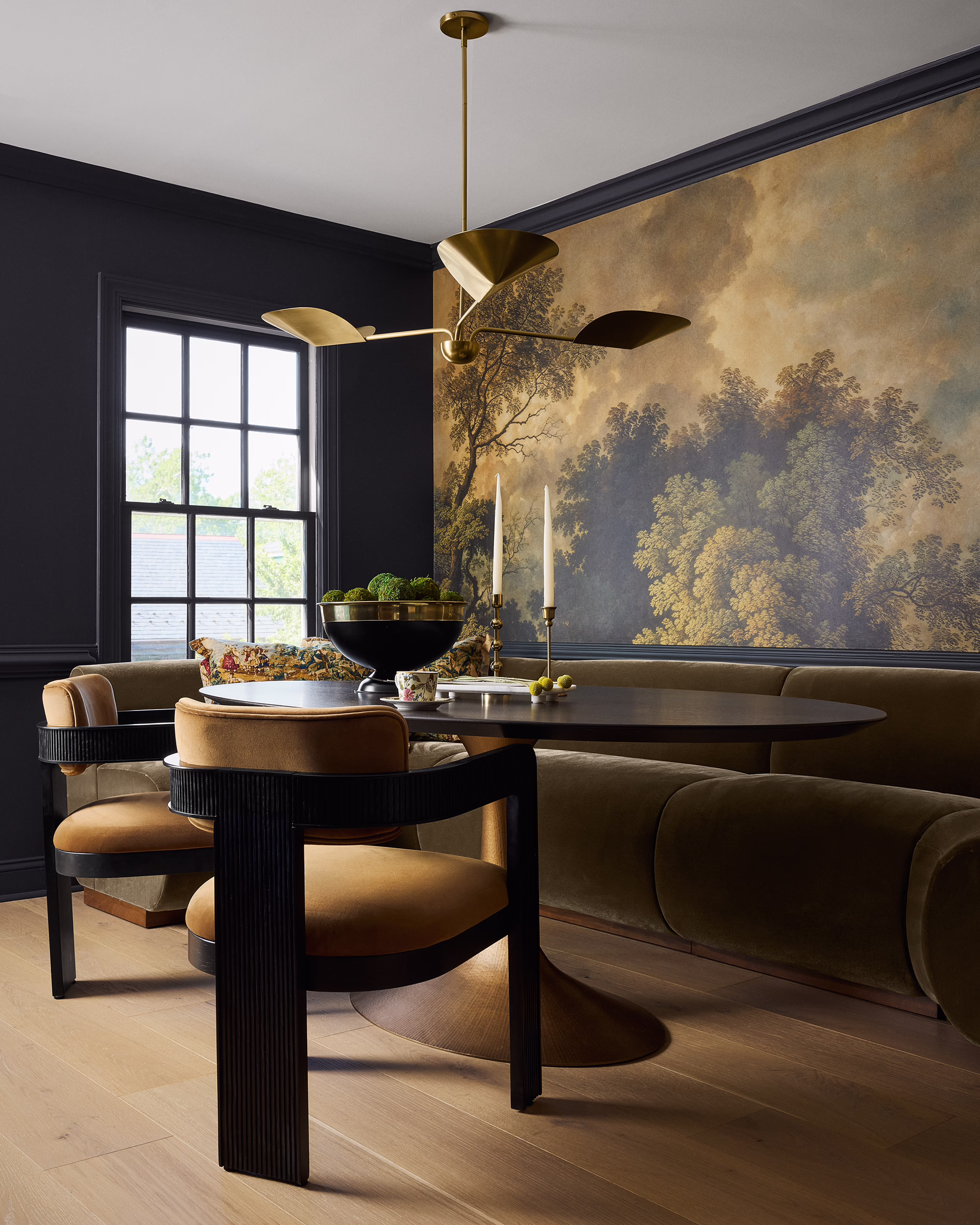 Kings Ct. dining nook with a landscape mural, curved banquette and brass chandelier