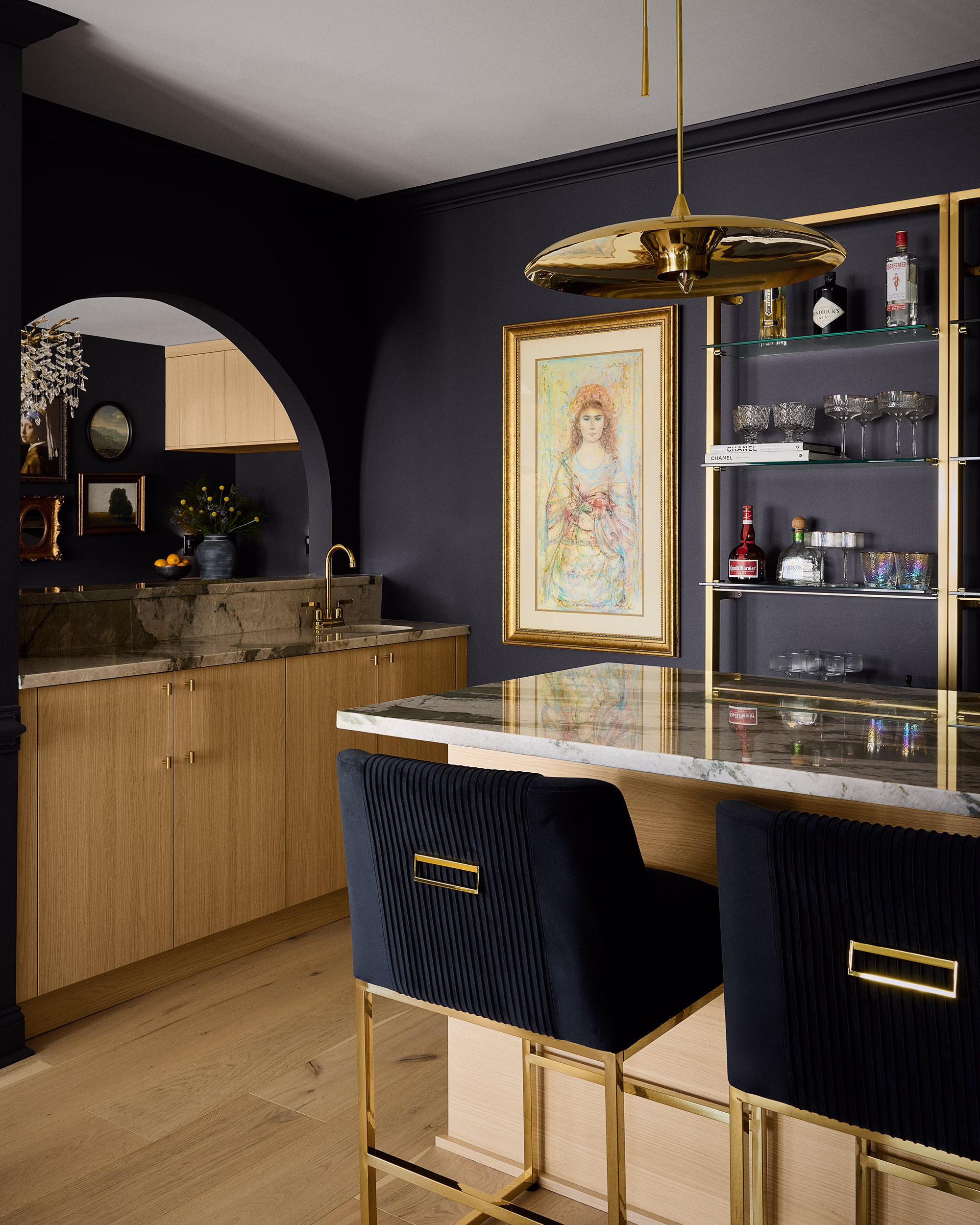 Kings Ct. home bar with black walls, light wood cabinetry and navy stools